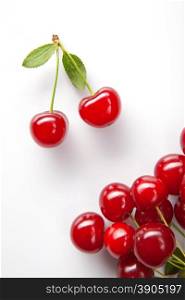 Red cherry with leaves on white