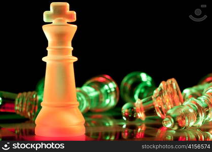 red chess king defeated green enemies on board in dark