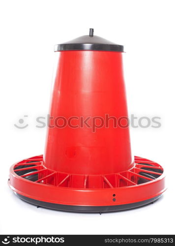 red chicken feeder in front of white background