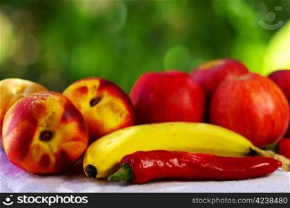 Red chili and fruits on table
