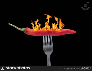 Red chili pepper is pierced a fork with fire,food concept