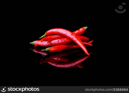 Red chili pepper on black background