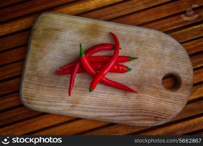 Red chili pepper on wooden background