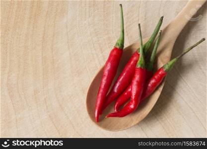red chili pepper on wooden table,closeup view