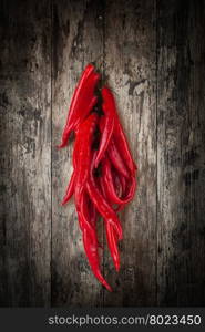 Red chili pepper. Red chili pepper isolated on a wooden background