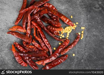 Red chili pepper seed / dried chillies on dark background , top view