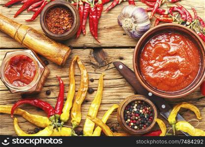 Red chili peppers and chili sauce.Chilli sauce with ingredients. Chili sauce in bowl