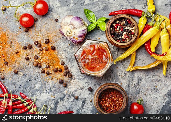 Red chili peppers and chili sauce.Spicy sauce for meat food. Spicy chili sauce or ketchup