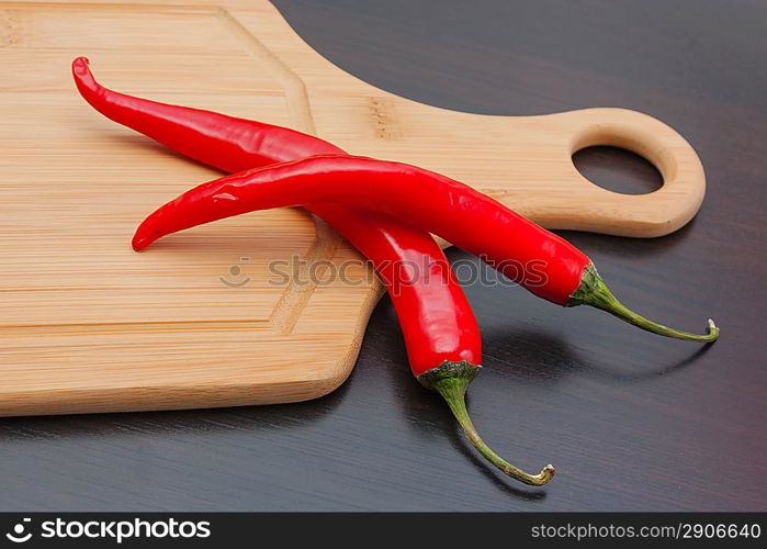 Red chili peppers on a cutting board