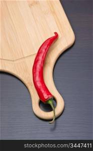 Red chili peppers on a cutting board