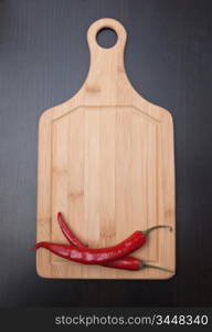 Red chili peppers on a cutting board