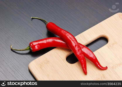 Red chili peppers on a cutting board