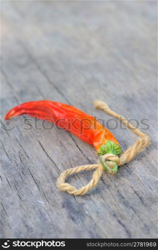 Red chili peppers over wooden background
