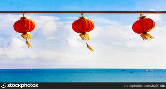 Red Chinese Paper Lanterns against a Blue Sky and sea