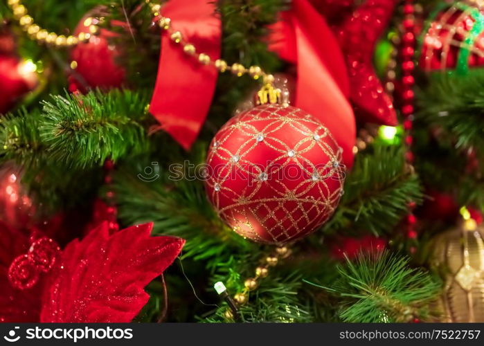 Red Christmas ball hanging on Christmas tree.