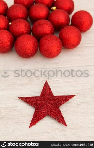 Red Christmas balls and star with glitter. Tree decorations