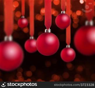 red christmas balls hung with red ribbons