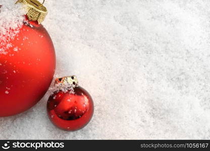 Red Christmas balls in the snow