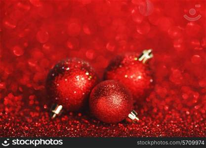 Red christmas balls over shiny glitter background