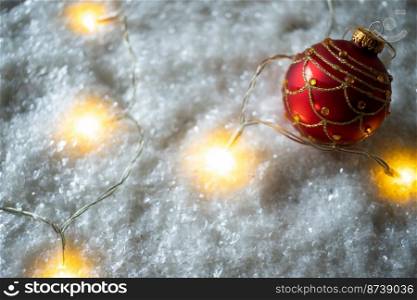 red Christmas bauble in snow