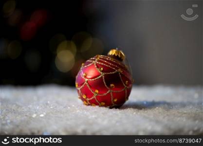 red Christmas bauble in snow