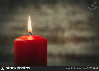 Red Christmas candle on a white wooden background