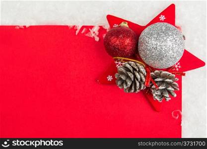 Red Christmas celebration card and christmas balls and star on snow
