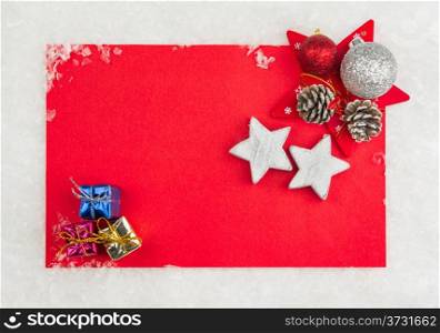 Red Christmas celebration card with small gift boxes and stars on snow