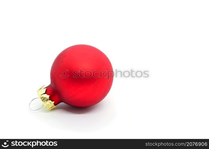 Red Christmas ornament ball on white background. Copy space on the right.