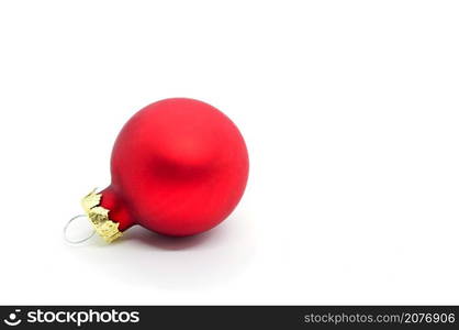 Red Christmas ornament ball on white background. Copy space on the right.