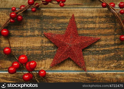 Red Christmas star on a rustic wooden background