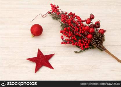 Red Christmas star on gray wooden background and red berries