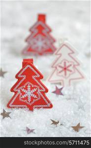 red christmas tree of wood and silver stars on snow background