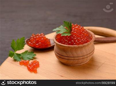red chum salmon caviar in a wooden bowl, delicious and healthy food, close up