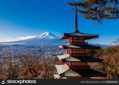 Red Chureito Pagoda and Snow covered Mount Fuji blue sky in autumn. Shimoyoshida - Arakurayama Sengen Park in Fujiyoshida near Kawaguchigo