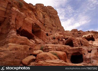 Red cliff and caves in mountain Petra, Jordan