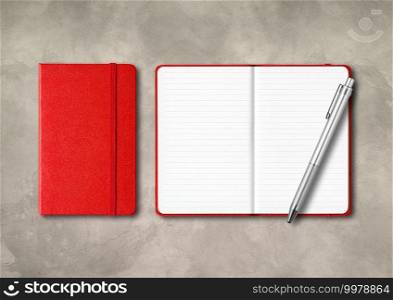 Red closed and open lined notebooks with a pen . Mockup isolated on concrete background. Red closed and open lined notebooks with a pen on concrete background
