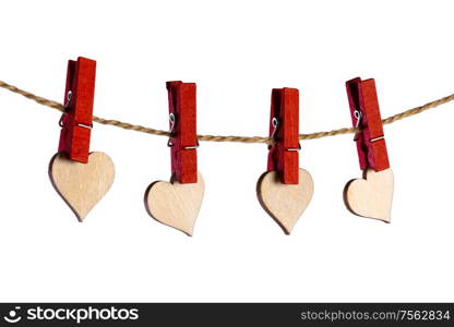 Red clothes pegs and wooden hearts on rope isolated on white background. Valentines day concept. Clothes pegs and hearts