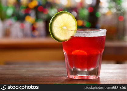 red cocktail in a bar