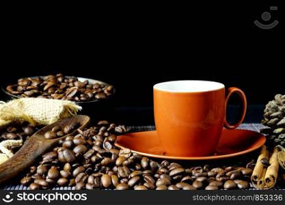 Red coffee cup and coffee beans on dark background