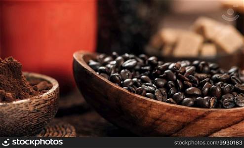 Red coffee cup, coffee beans and ground coffee in wooden bowl on table. Making coffee concept