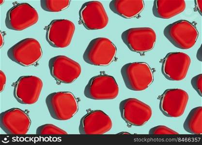 Red Coin Purse on blue background. Minimal flat lay texture. Minimal financial and money saving pattern concept.