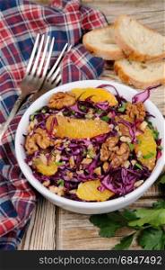 red coleslaw salad with slices of oranges and walnuts