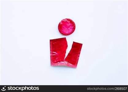 Red condom on white background.