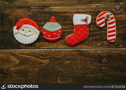 Red cookies for Christmas on a wooden background