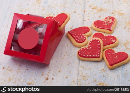 Red cookies in the shape of a heart in a gift box on wooden boards close-up on Valentine&rsquo;s Day. cookies in the shape of hearts on Valentine&rsquo;s Day
