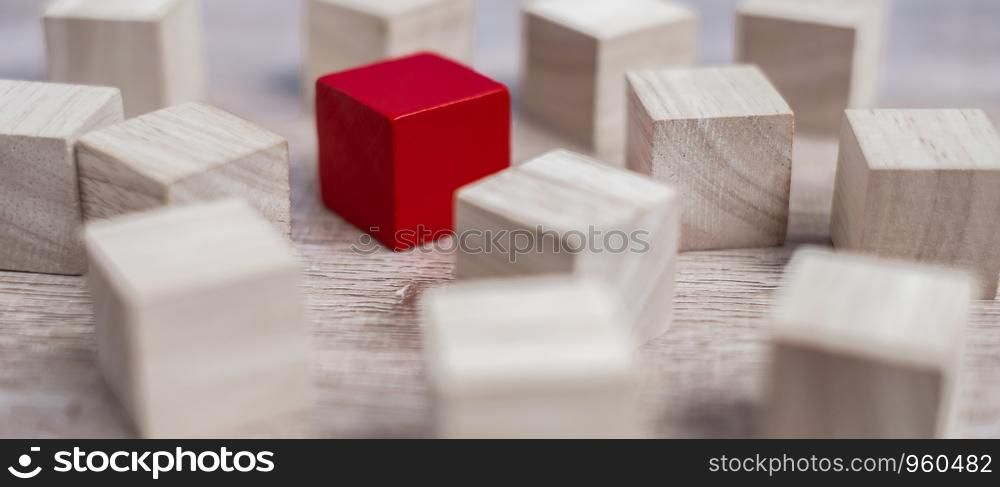 Red cube block different from crowd of wood blocks. Unique Leader, strategy, independence, think different, business and success concept