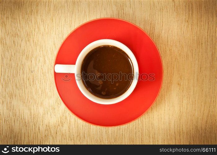 red cup of hot coffee on wood background