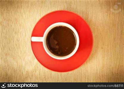 red cup of hot coffee on wood background