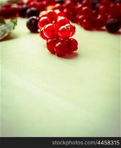 red currant berries on wooden background